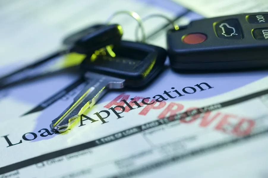 An auto loan approved with a set of car keys laying on top